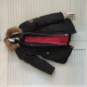 A warm winter coat with a fluffy hood Tag still on